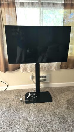 LG TV with floor stand and extra TV table
