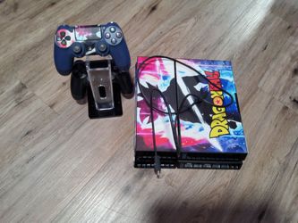 PS4 Console with Dragon Ball Skin and Two Controllers