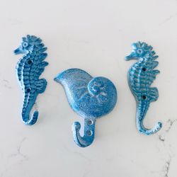 Set of 3 cast heavy cast metal aqua blue wall hooks  2 seahorses 5” tall x 2” wide  1 seashell 4” tall x 3 3/4” wide