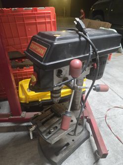 This is a compact Craftsman 9-inch 5-speed benchtop drill press (commonly model series 137.219090), equipped with a utility drill press vise clamped t