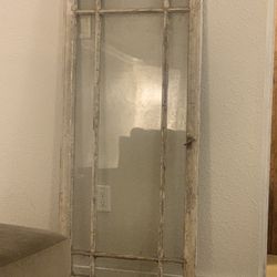 Old salvaged wooden window frame with original glass panes