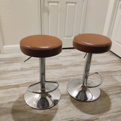 Two Caramel Colored Adjustable Bar Stools