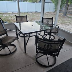 Patio Table And 4 Swivel Rockers.