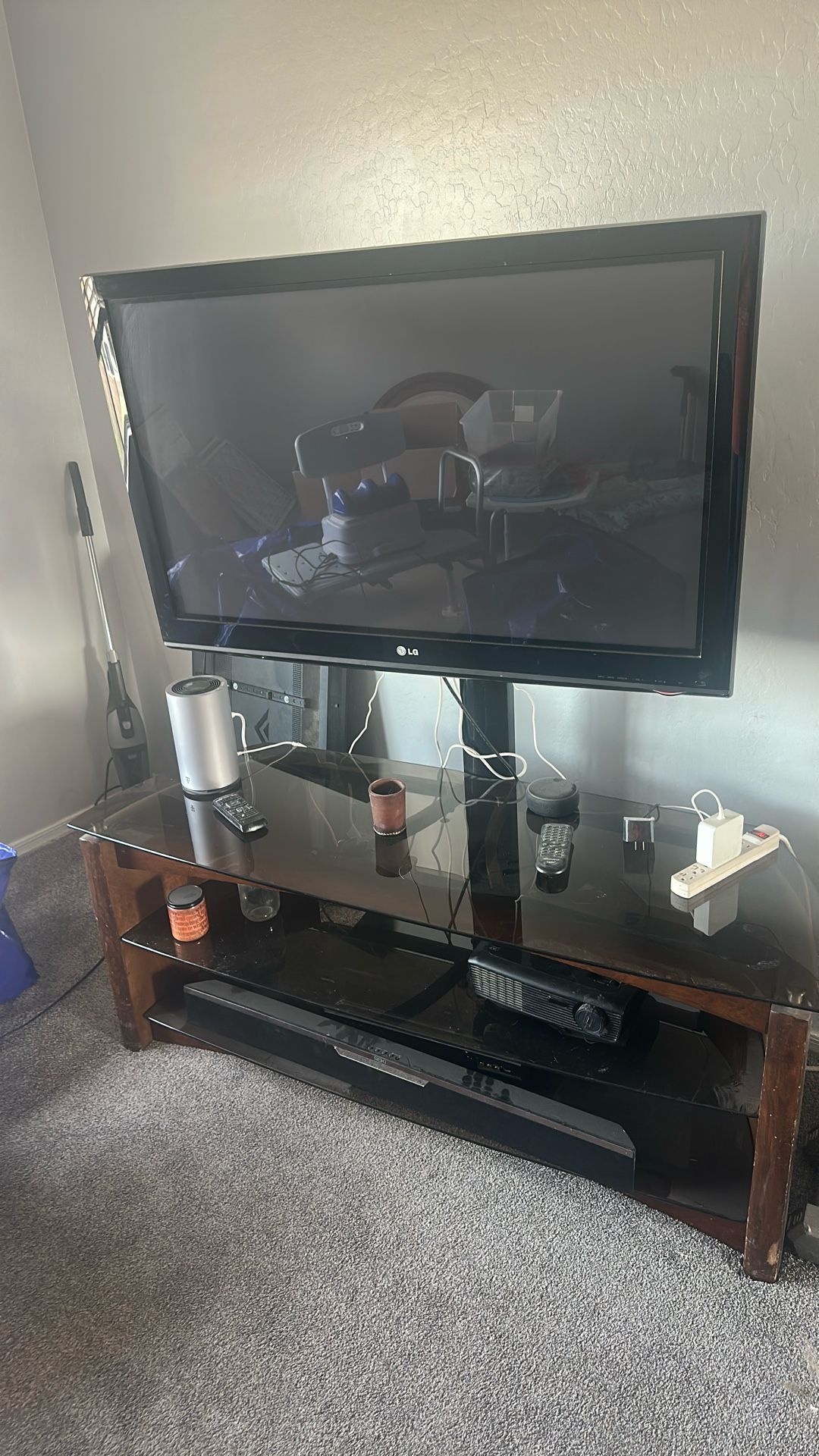 LG 40 inch smart TV with glass shelf entertainment center