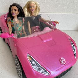 pink barbie car and 2 barbie dolls