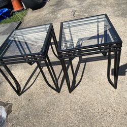  accent side tables featuring black iron frames and glass tops.
