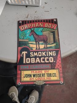 Vintage orphan boy smoking tobaccos sign