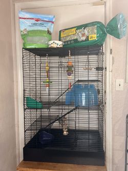 Multi-level small animal cage with accessories.