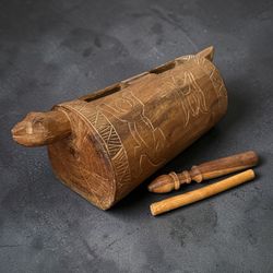 Authentic Hand Made Nigerian Ekwe Drum Condition Good condition with minor surface wear and natural aging consistent with use. Includes a matching car