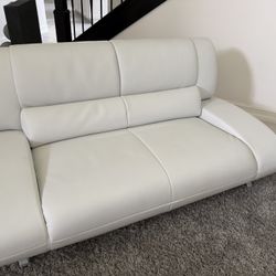 White Leatherette Sofa Set With Cocktail Table And Rug