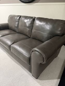 Beautiful leather sofa that matches about 6 1/2 feet long, comfortable, and in great condition . Gray Leather Accent Chair