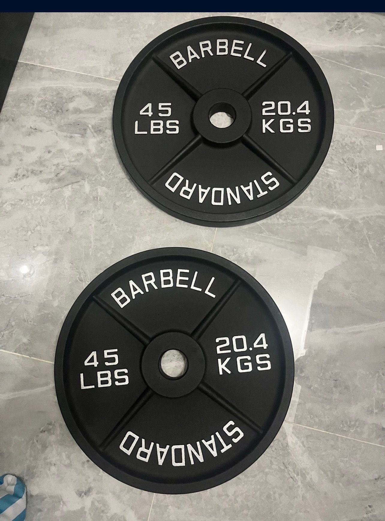 New in box pair of 45lb Olympic weight plates total 90lb have ez curl bar new in bag for sale too for additional price