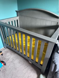 Grey crib with Newton mattress