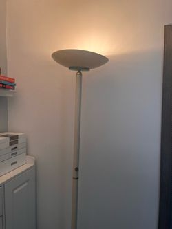 vintage-style white metal torchiere floor lamp.