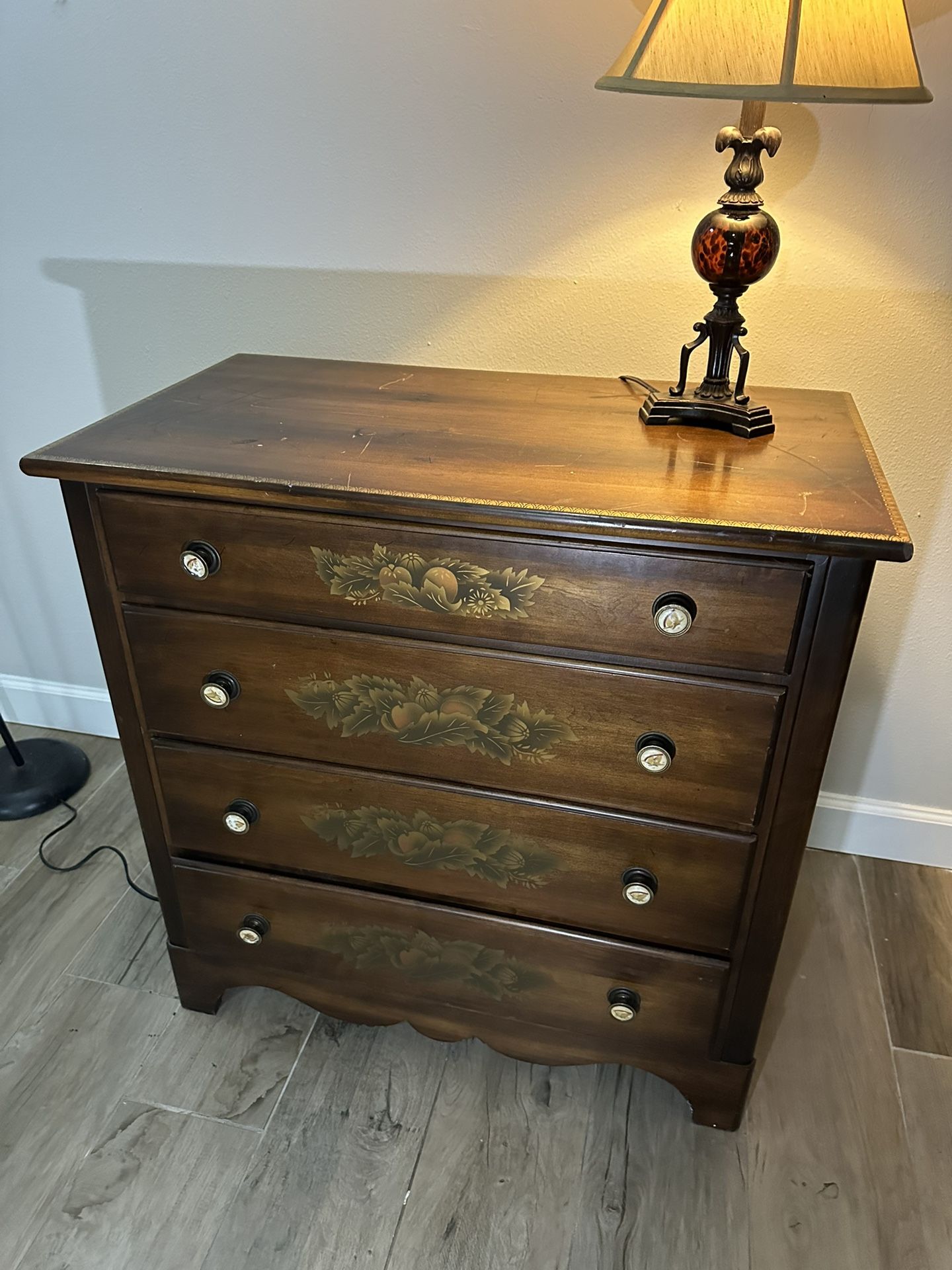 Four drawer Lambert Hitchcock dresser with stenciling on the drawers and eagle knobs.