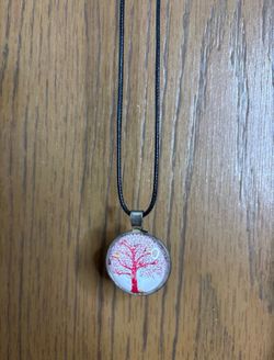 Necklace with a pendant of a pink tree