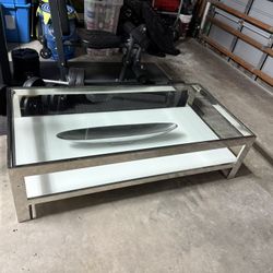 Rectangle  Coffee Table, Heavy, was $1,100. Stainless Steel Frame, Tempered Glass, Perfect Condition Size: 55W x 15H x 27.                      