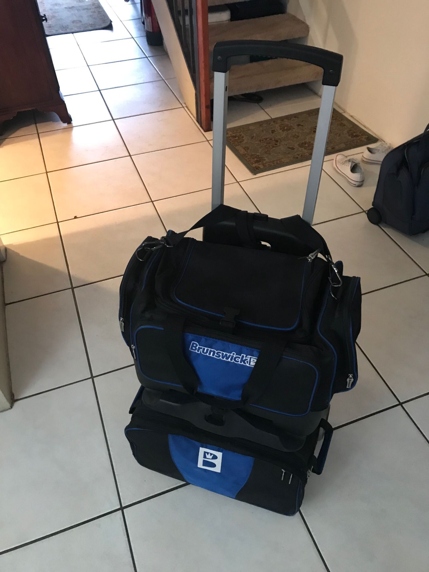 Brunswick Razor 4 Ball Rolling Bowling Bag. Black/ Blue. New Condition Separate shoe compartment holds up to size 15 shoes. Multiple front and side a