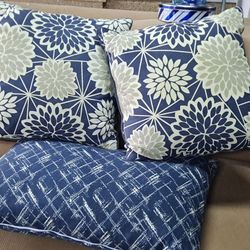 Decorative Pillows And A Flower Vase .