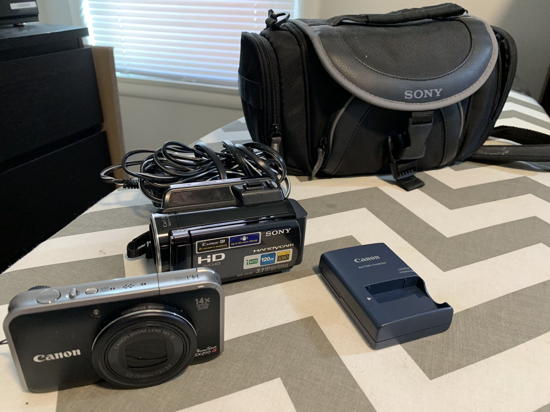 Sony HDR XR150 (25x Optical Zoom) and Canon Powershot SX210 with Travel Bag