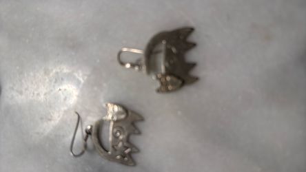 Women's silver earings with feline and horoscope design.
