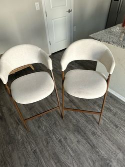 2 beige high chairs