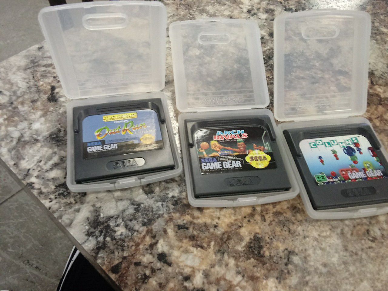 Lot of 3 Sega Game Gear games with carrying cases.