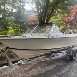 Very capable 16’ Olympic with newer 115 hp Evinrude E-tec engine And EZ Loader trailer