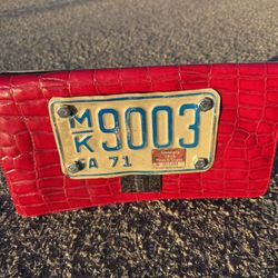 Vintage red clutch with vintage motorcycle plate