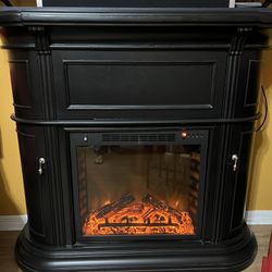 Black Fireplace With a Storage Cabinet On Top And Open Side Storage. Well Maintain few Scratches Barely Noticeable, Like New