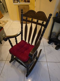 Dark Wood Rocking Chair with Carved Back