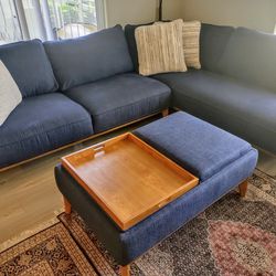 Delivery is free today. Blue sectional couch in like new condition. Ottoman included. no stains.