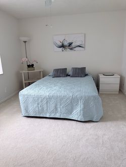 Queen size mattress with bedframe and side table