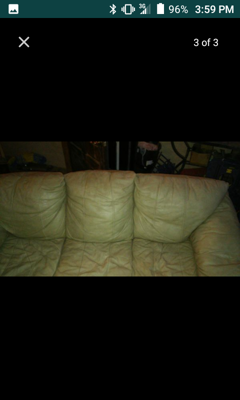 Tan leather reclining sofa and love seat