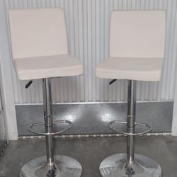 2 white faux leather adjustable height bar stools