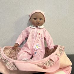 Girl Baby Doll in a pink carrier