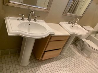 TWO KHOLER PEDESTAL SINKS WITHE NICKEL PLATED FAUCETS