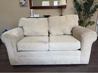 Two tan love couches