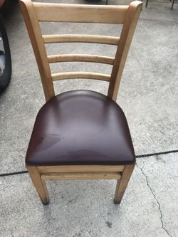 Light wood chairs burgundy cushion.