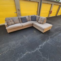 2pc Grey Sectional W/ Throw Pillows.  $500. Will Deliver For A Fee 