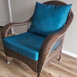 Brown Wicker Armchair with Teal Cushions