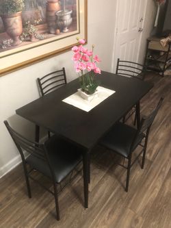 Like new black dining table set with 4 leather chairs