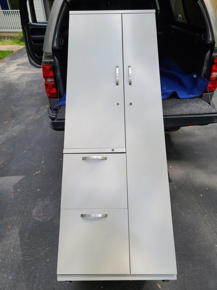 Tall locking  metal locker with draws 