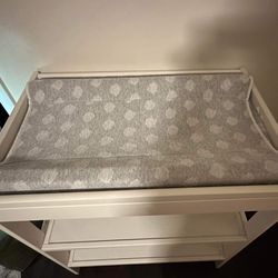 White changing table including changing pad and removable, washable cover.
