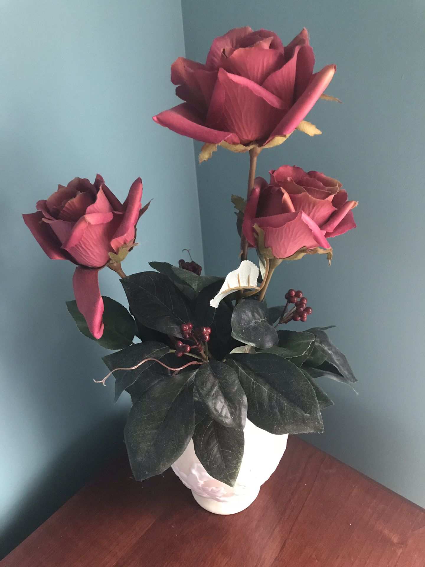 Artificial red rose plant with white vase