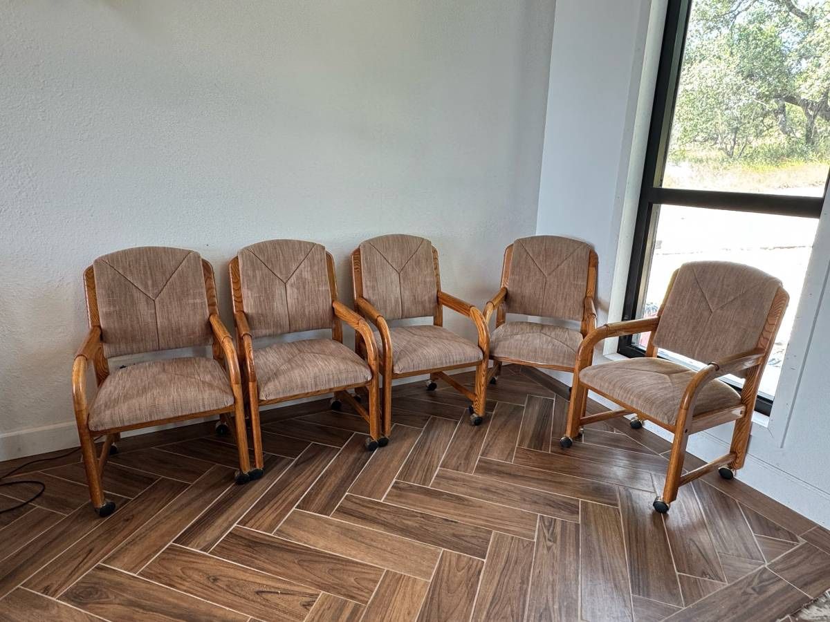 5 cushioned wood chairs on casters