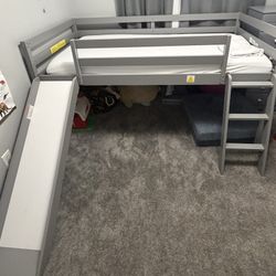 Toddler bed frame with slide. Mattress w/ pee resistant cover included.