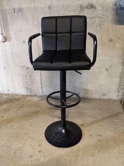 Black, adjustable bar stool 

