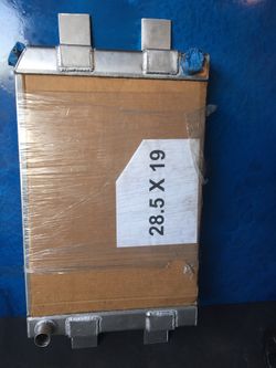 28-1/2” wide 19” tall aluminum radiator never mounted or used. Has 4 welded tabs on side for a more mounting options