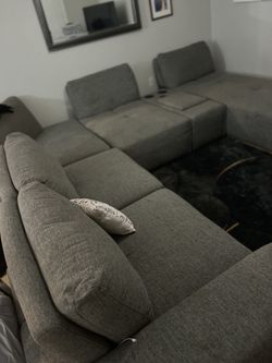 Grey Sectional Sofa with Built-In Speakers and Storage Console